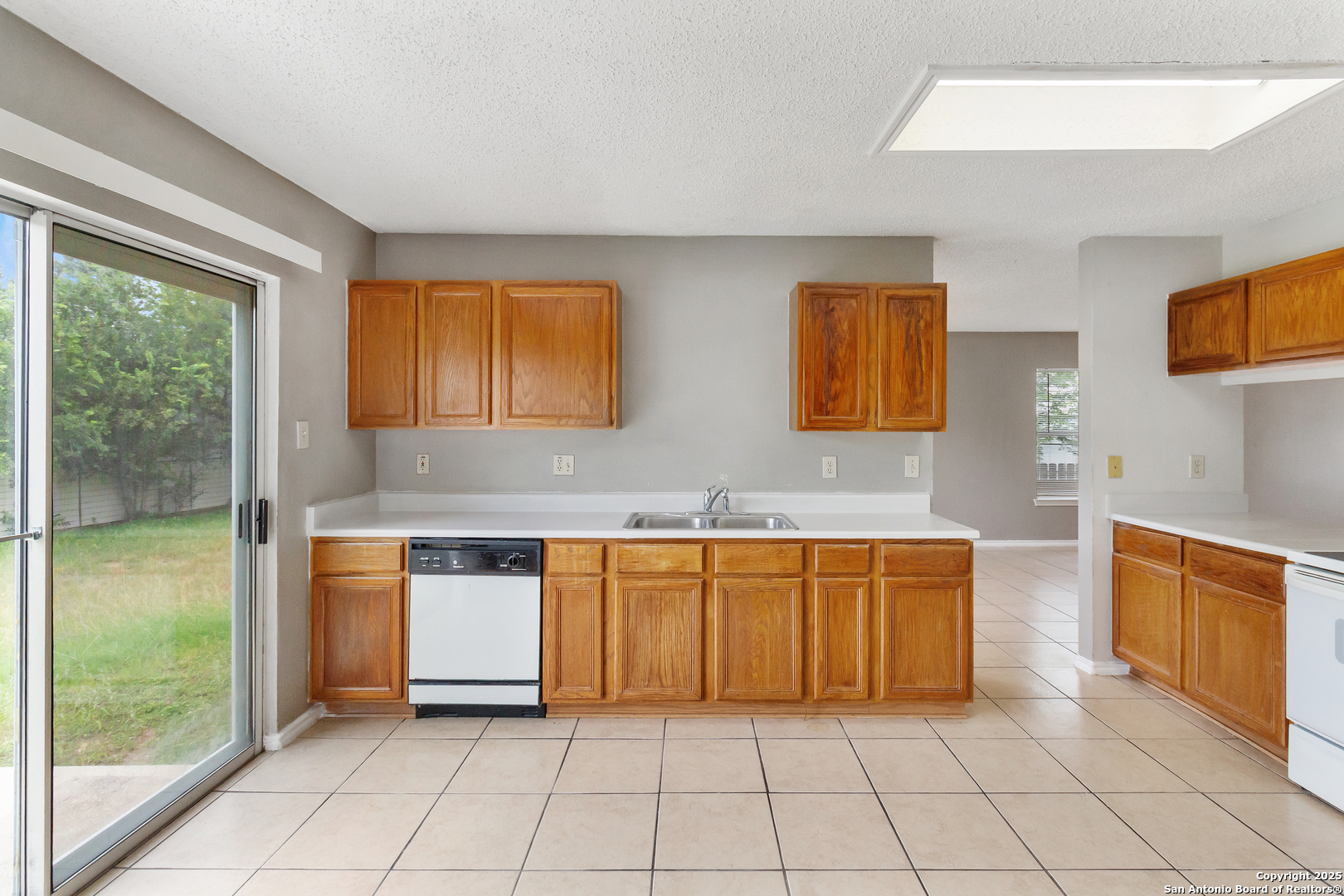 8310 Border Ridge Drive San Antonio, TX 78240 - Photo 10 of 24 a kitchen with stainless steel appliances granite countertop a refrigerator and a sink