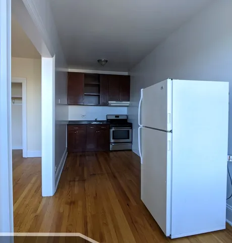 a kitchen with a refrigerator and a stove