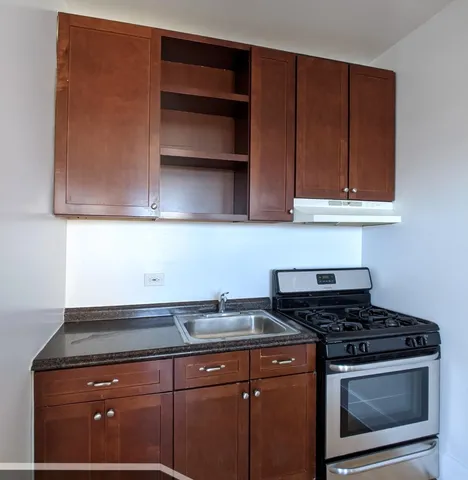 a stove top oven sitting inside of a kitchen