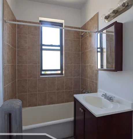 a bathroom with a sink mirror toilet and bathtub