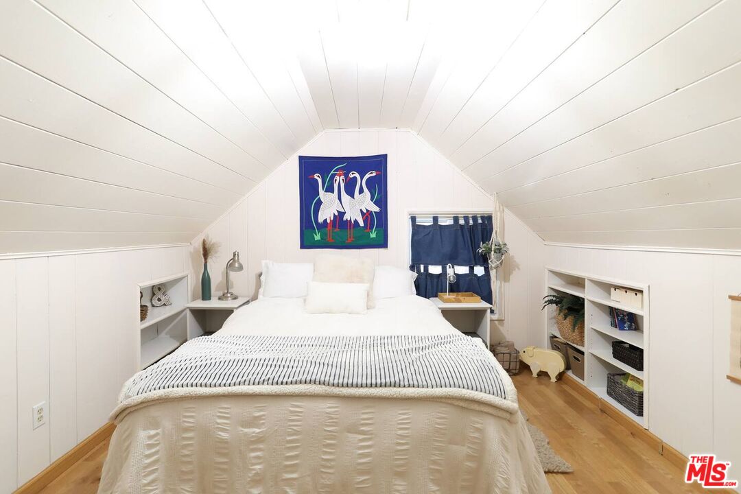 52521 Pine Ridge Road Idyllwild, CA 92549 - Photo 14 of 43 a bedroom with a large bed and a book shelf