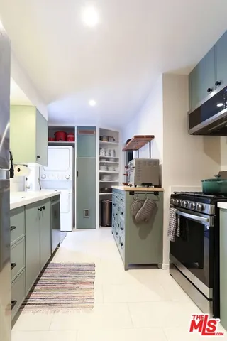 a kitchen with a stove top oven and cabinets