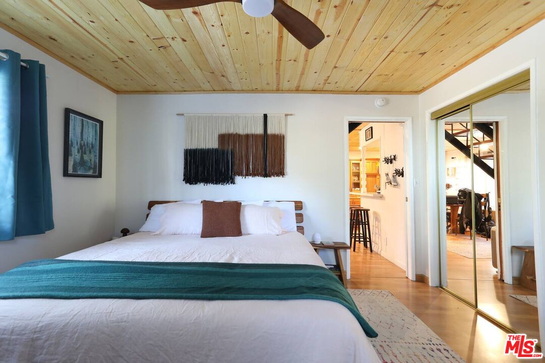 52521 Pine Ridge Road Idyllwild, CA 92549 - Photo 25 of 43 a bedroom with a bed and wooden floor