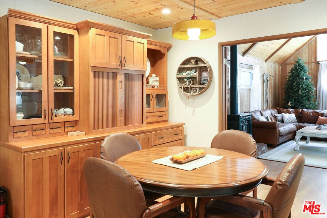 52521 Pine Ridge Road Idyllwild, CA 92549 - Photo 28 of 43 a view of a dining room with furniture and a large window