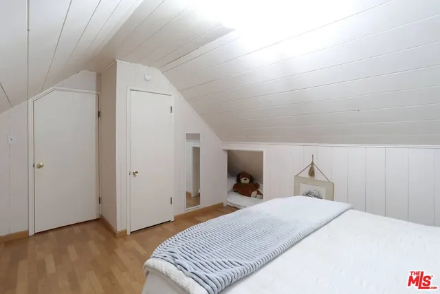 a hallway with a stove a dining table and chairs with wooden floor