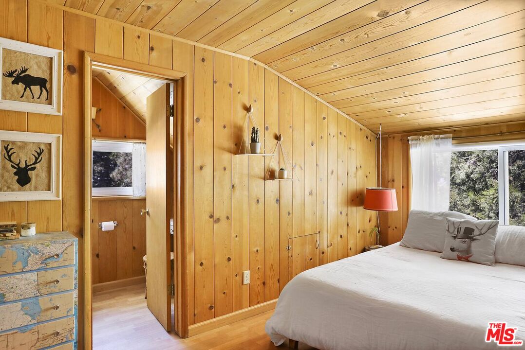 52521 Pine Ridge Road Idyllwild, CA 92549 - Photo 36 of 43 a bedroom with a bed and wooden floor