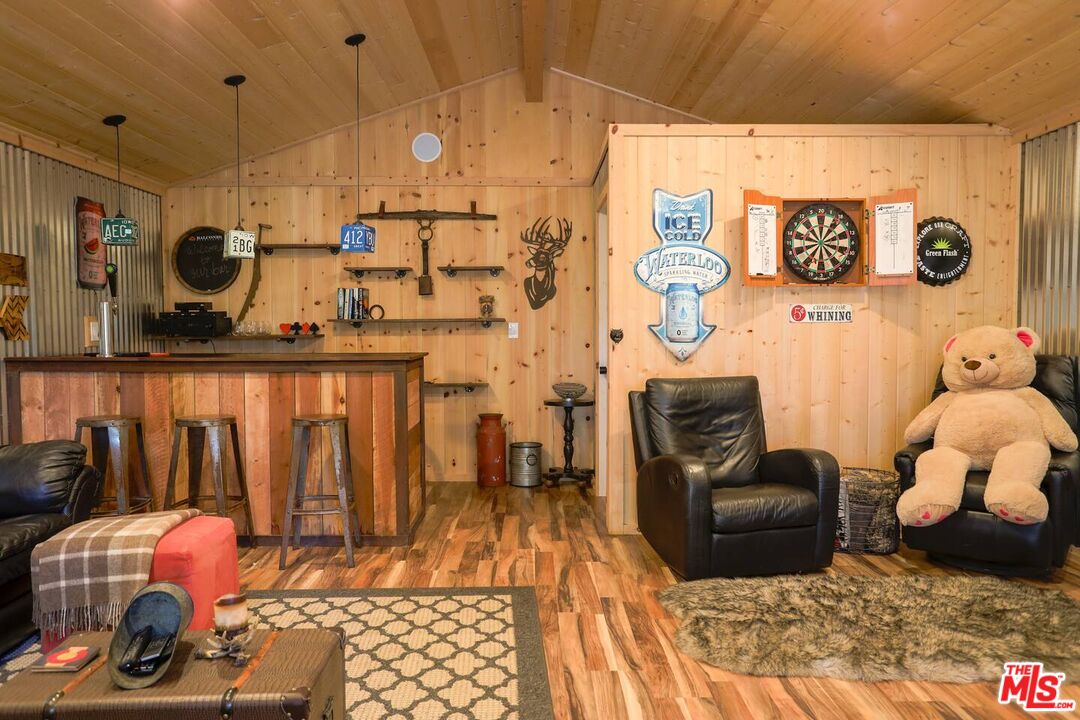 52521 Pine Ridge Road Idyllwild, CA 92549 - Photo 37 of 43 a hallway with a stove a dining table and chairs with wooden floor