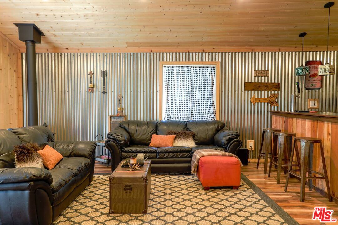 52521 Pine Ridge Road Idyllwild, CA 92549 - Photo 38 of 43 a living room with furniture and a floor to ceiling window
