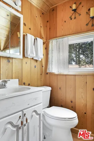 a bathroom with a sink a toilet and shower curtain