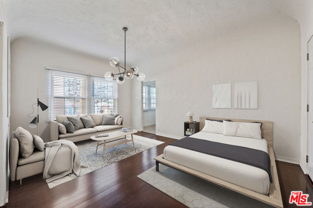 5320 West Olympic Boulevard, Unit 4 Los Angeles, CA 90036 - Photo 7 of 11 a bedroom with furniture and a chandelier