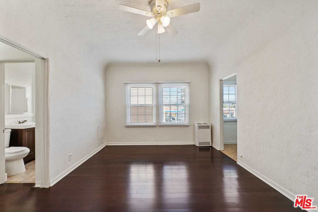 5320 West Olympic Boulevard, Unit 4 Los Angeles, CA 90036 - Photo 9 of 11 a view of an empty room with wooden floor and a window