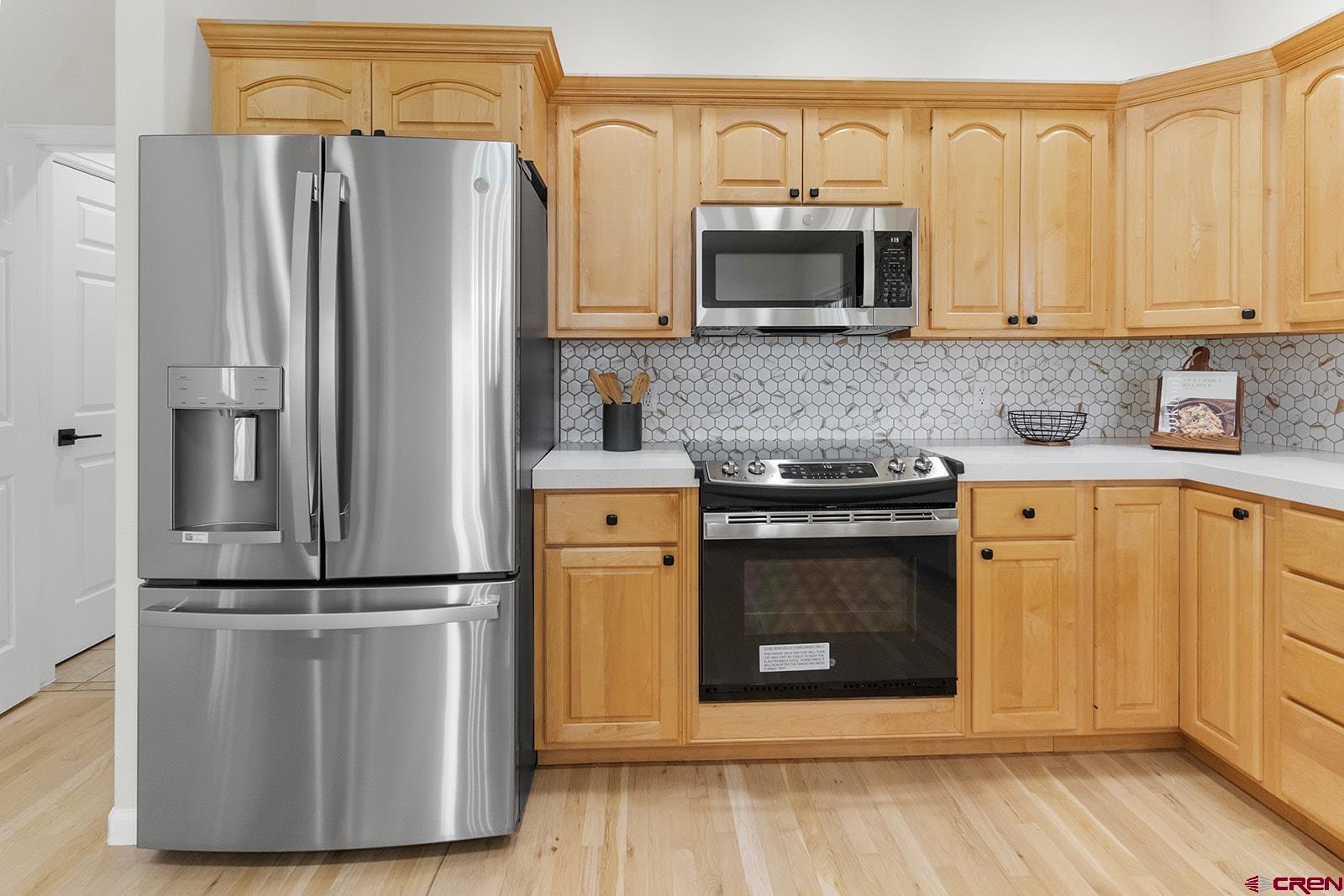66356 Otter Road Montrose, CO 81403 - Photo 11 of 45 a kitchen with stainless steel appliances granite countertop a refrigerator a stove top oven a sink and dishwasher