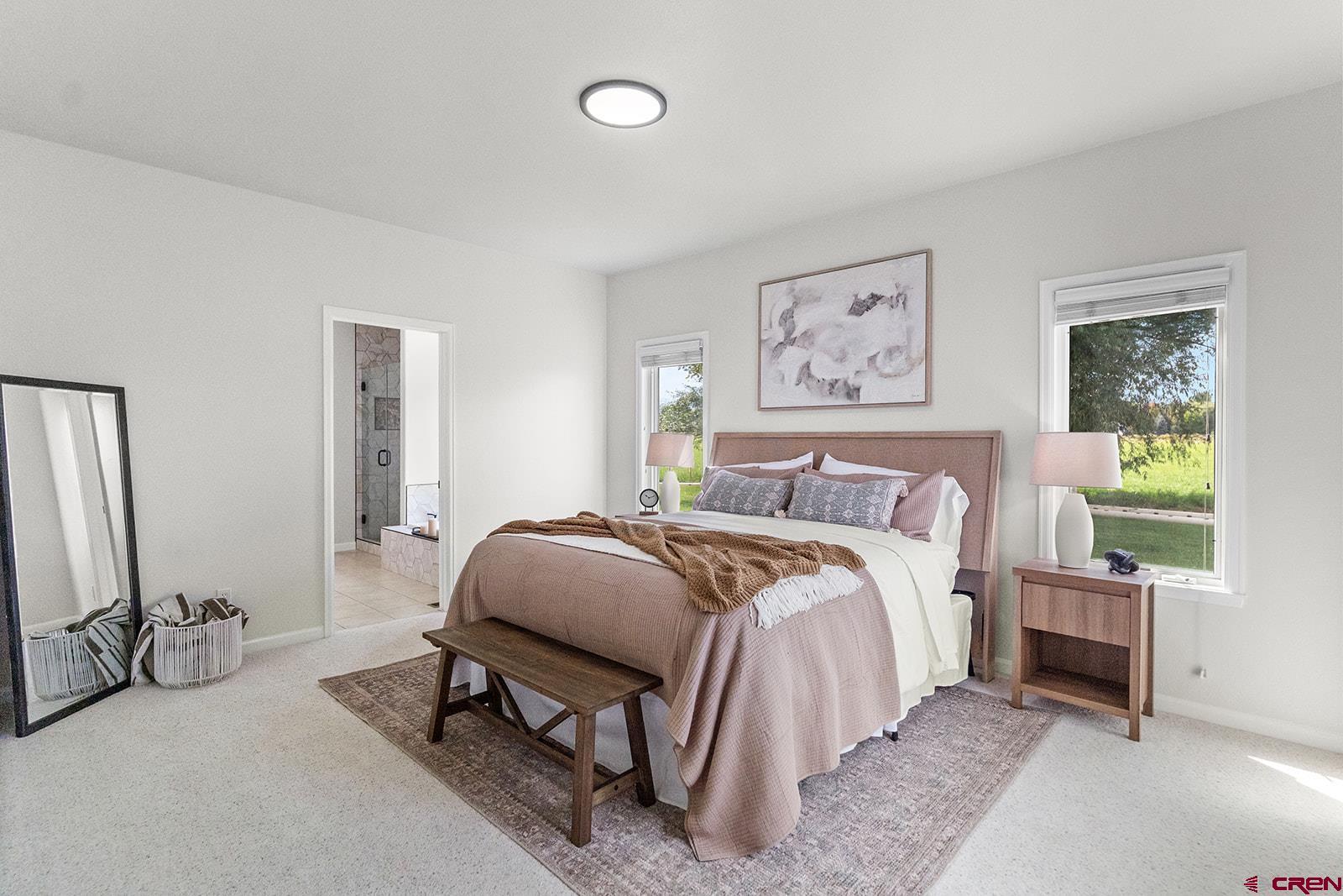 66356 Otter Road Montrose, CO 81403 - Photo 14 of 45 a spacious bedroom with a bed a couch and a window