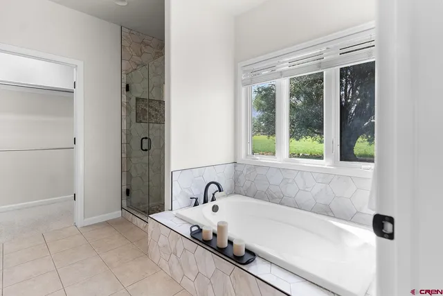 a spacious bathroom with a granite countertop sink a mirror and a toilet