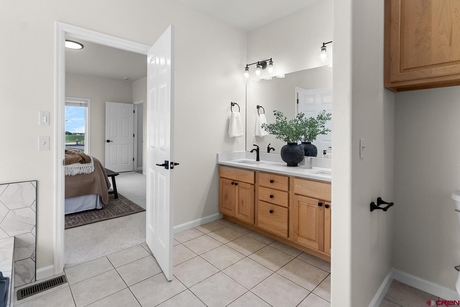 66356 Otter Road Montrose, CO 81403 - Photo 16 of 45 a spacious bathroom with a granite countertop sink a mirror and a toilet