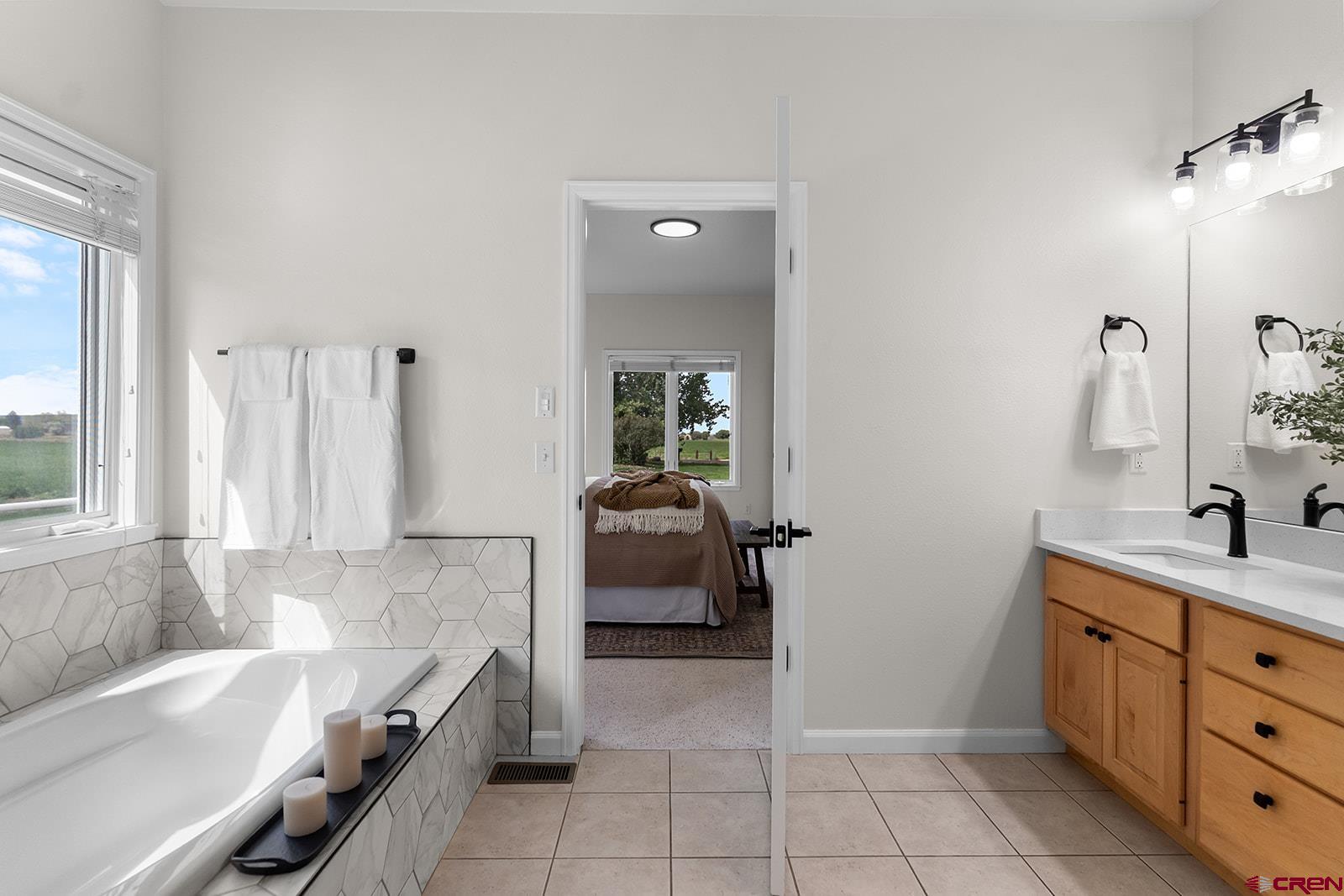 66356 Otter Road Montrose, CO 81403 - Photo 17 of 45 a bathroom with a tub sink and mirror