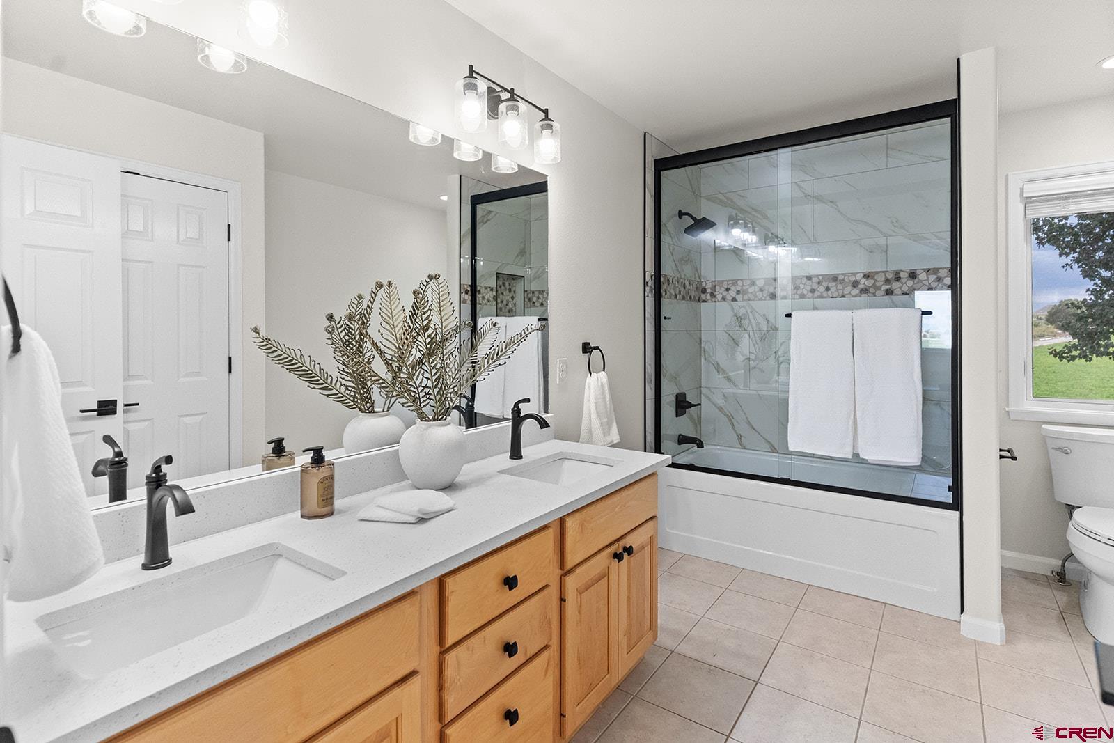 66356 Otter Road Montrose, CO 81403 - Photo 26 of 45 a bathroom with a granite countertop sink mirror and shower