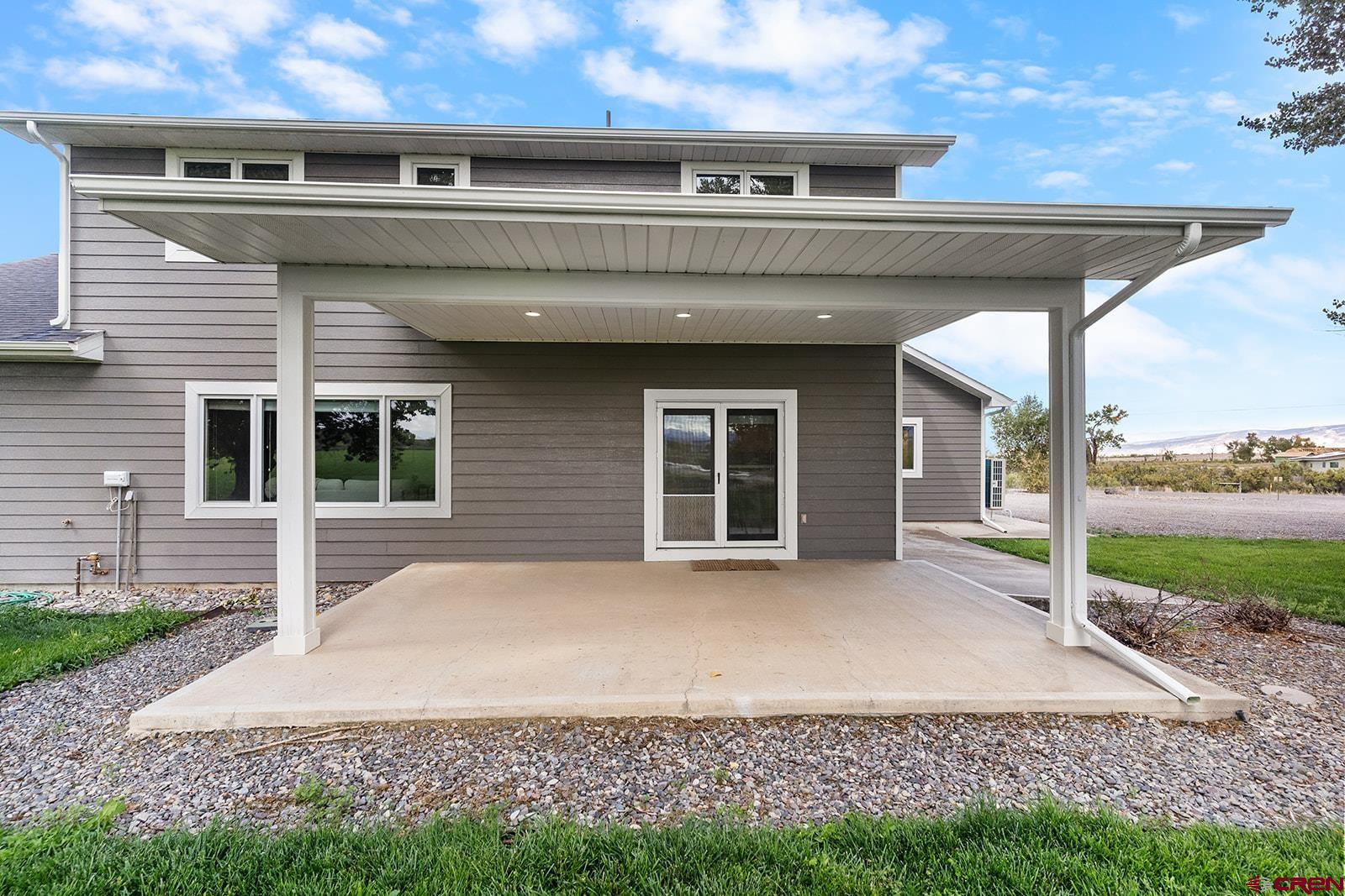 66356 Otter Road Montrose, CO 81403 - Photo 30 of 45 a front view of a house with a yard and garage
