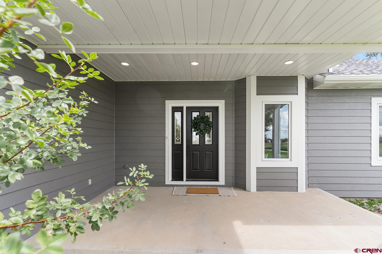 66356 Otter Road Montrose, CO 81403 - Photo 31 of 45 a front view of a house with flowers