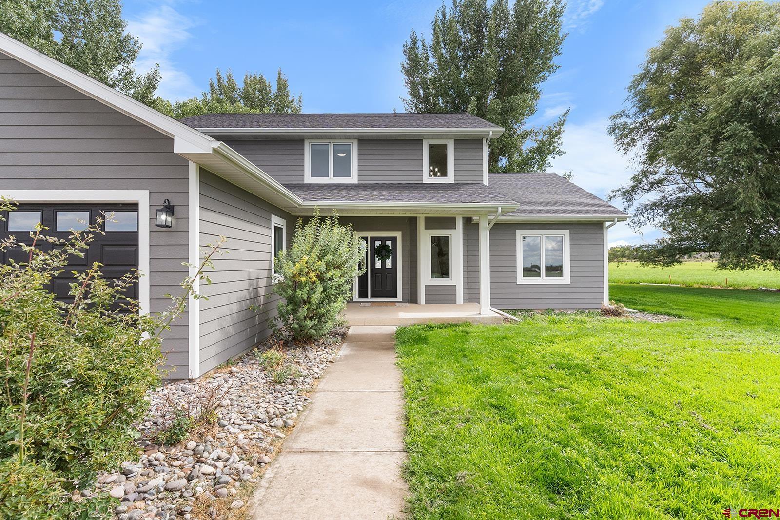 66356 Otter Road Montrose, CO 81403 - Photo 34 of 45 a front view of a house with garden