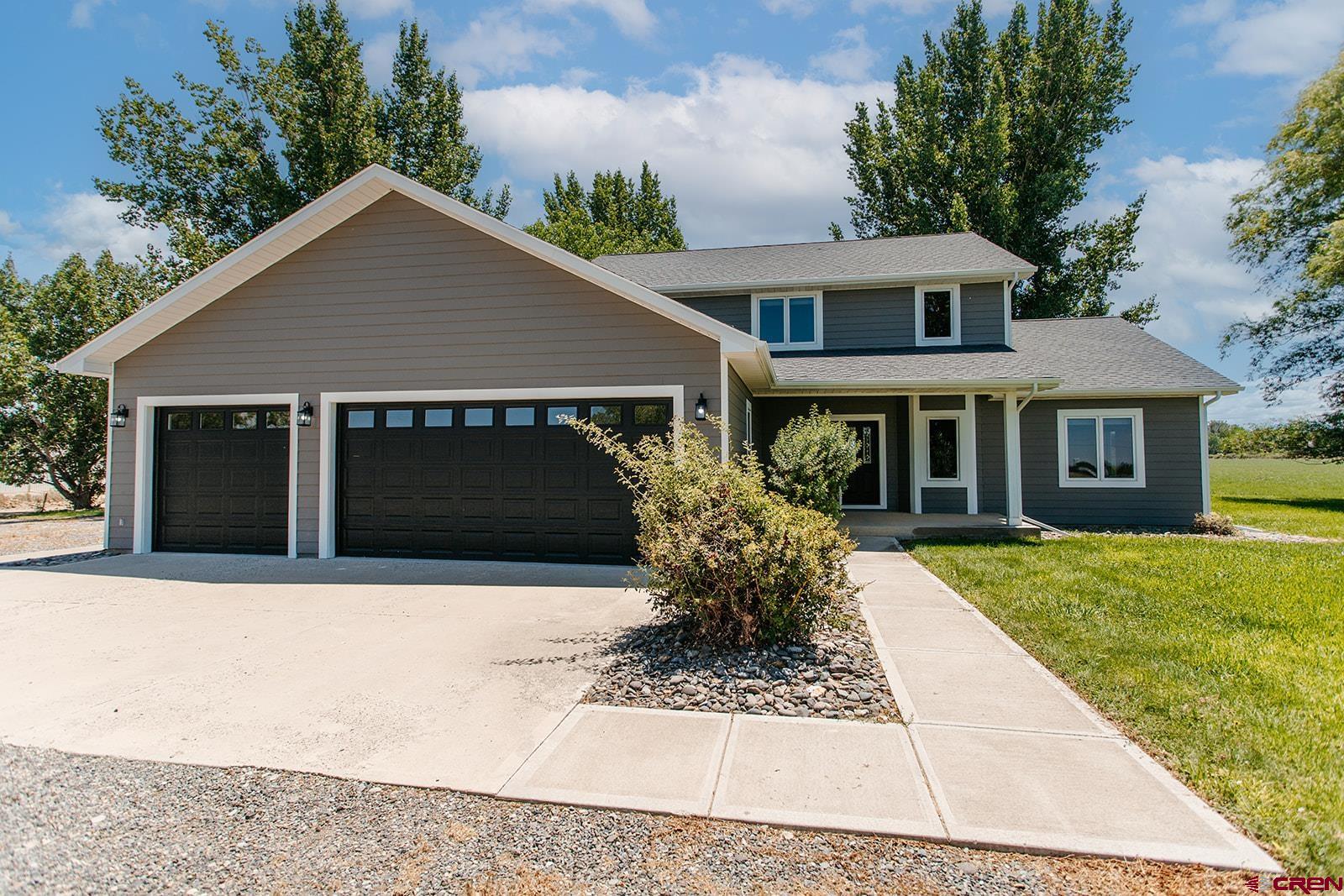 66356 Otter Road Montrose, CO 81403 - Photo 45 of 45 a front view of a house with a yard