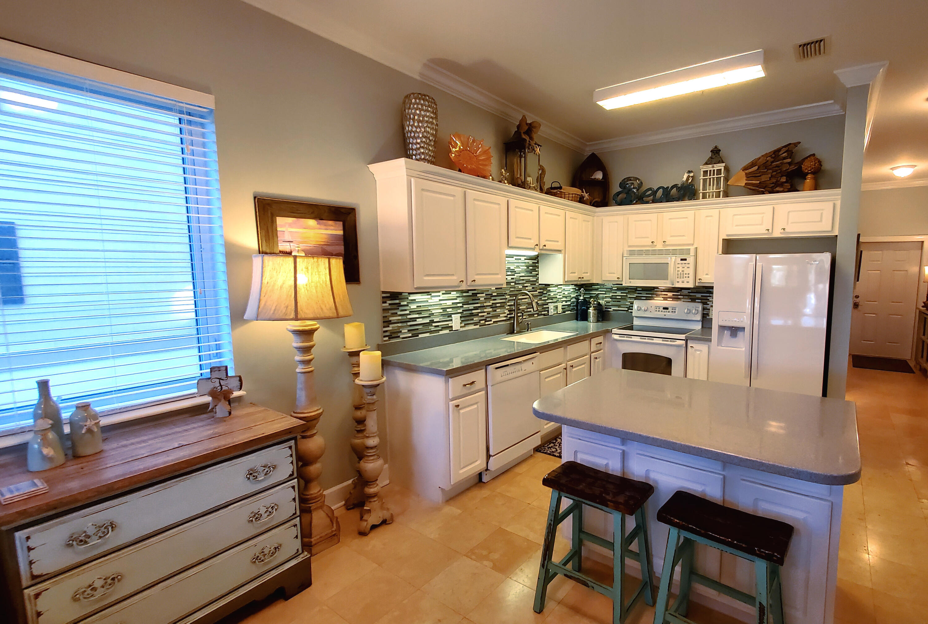 231 Somerset Bridge Road, Unit 2206 Santa Rosa Beach, FL 32459 - Photo 1 of 23 a kitchen with stainless steel appliances kitchen island granite countertop a table chairs and a refrigerator