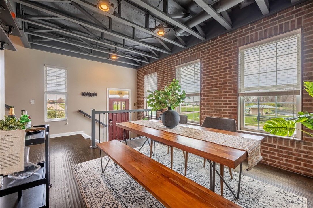 407 Brownstone Row Springboro, OH 45066 - Photo 7 of 54 This versatile dining area boasts a unique exposed ceiling and rich brick accent walls.