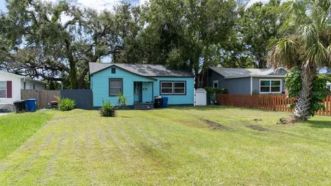 an aerial view of a residential houses with outdoor space