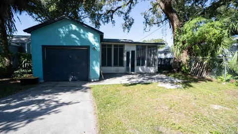 a view of a house with a yard patio and fire pit