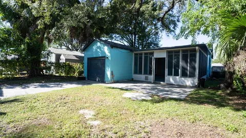 a view of a house with pool and sitting area