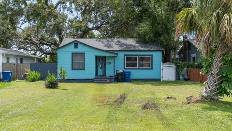 a green field with lots of trees