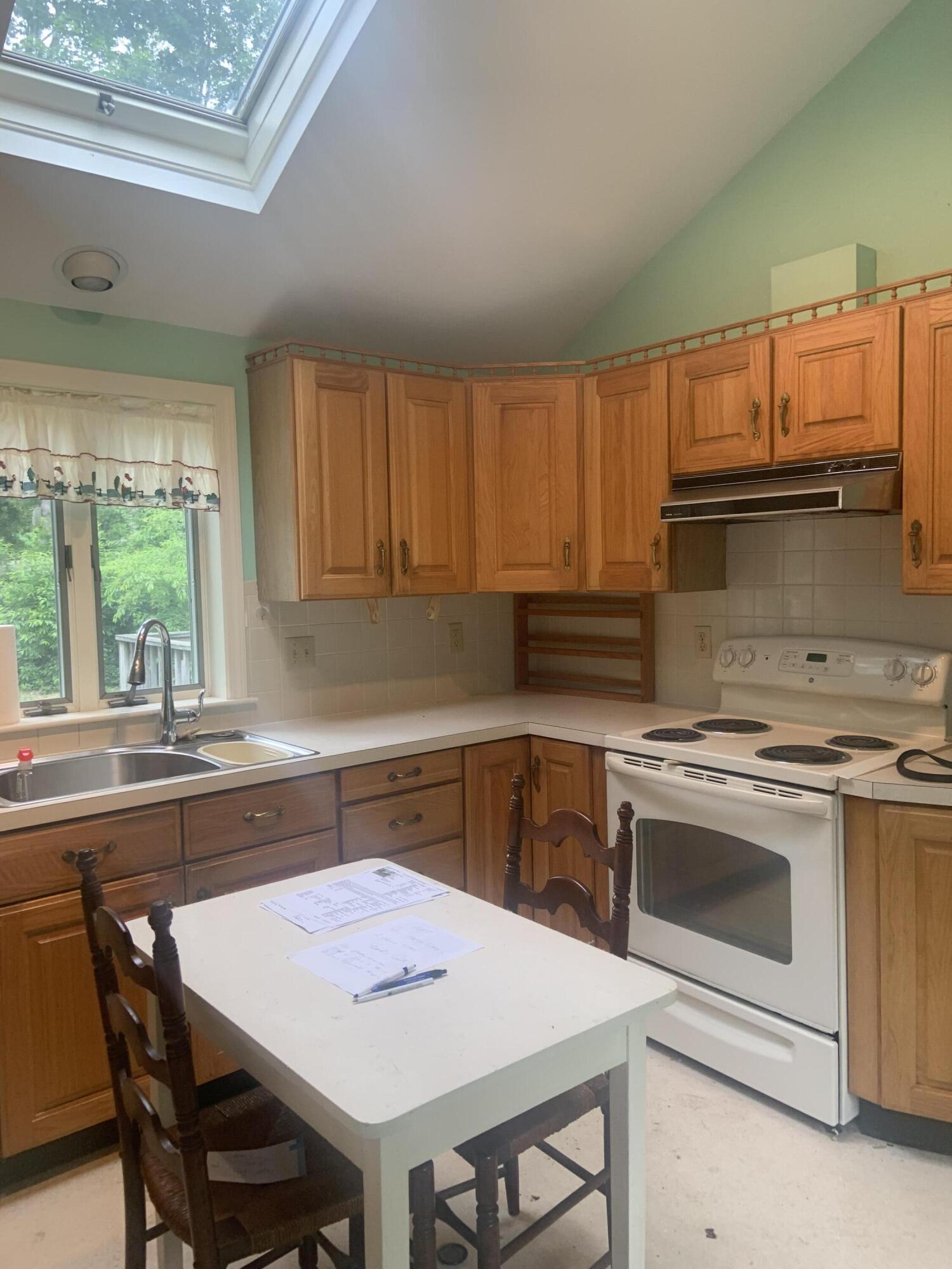 121 Longfellow Drive Centerville, MA 02632 - Photo 3 of 15 a kitchen with a stove a sink and a refrigerator