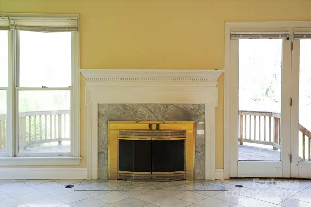 a living room with a fireplace and a window