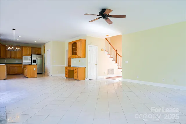 a view of a livingroom with a fireplace furniture and a ceiling fan