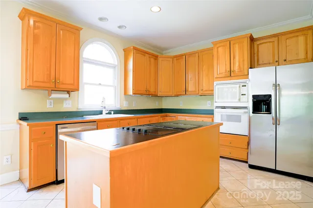a kitchen with wooden cabinets and a refrigerator