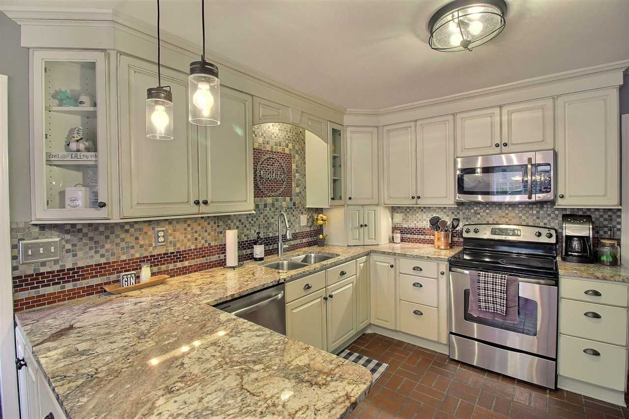 431 King Ridge Drive Collierville, TN 38017 - Photo 8 of 25 a kitchen with stainless steel appliances granite countertop a sink a stove and cabinets
