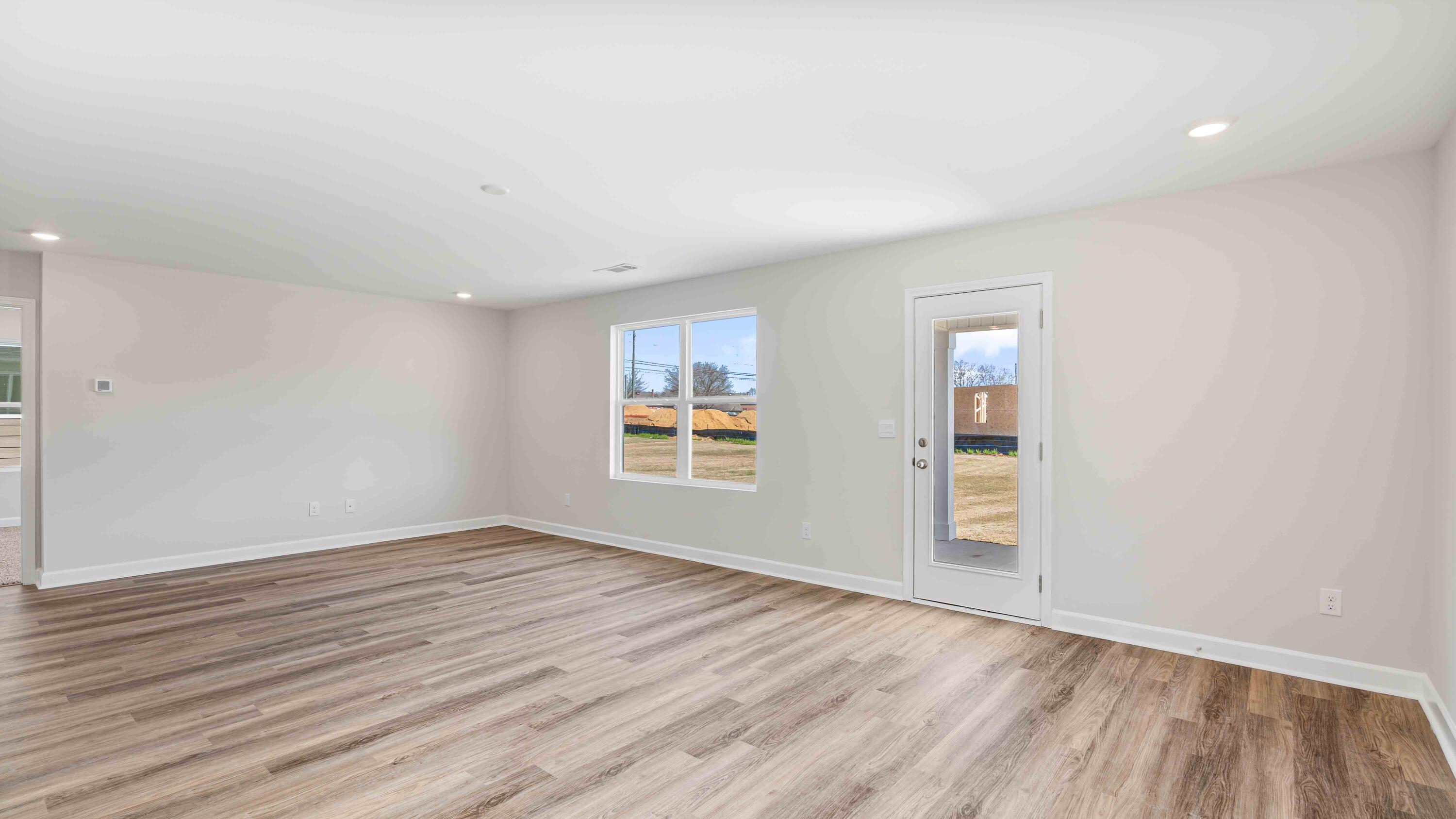 4611 Soldier Court Crestview, FL 32539 - Photo 8 of 14 an empty room with wooden floor and windows