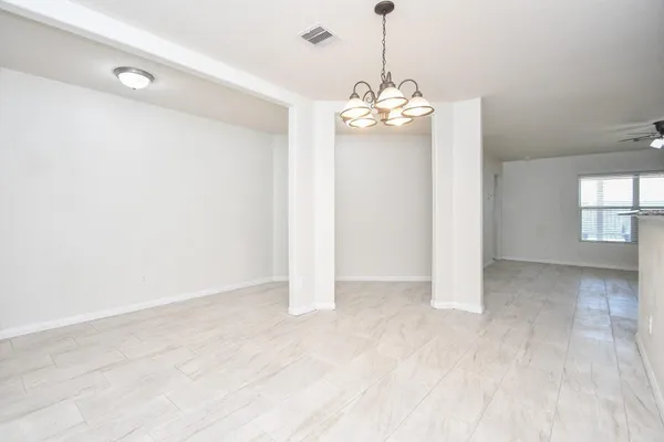 a kitchen with granite countertop a stove sink and microwave