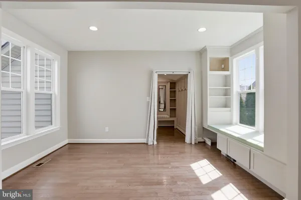 a view of an empty room with a ceiling fan