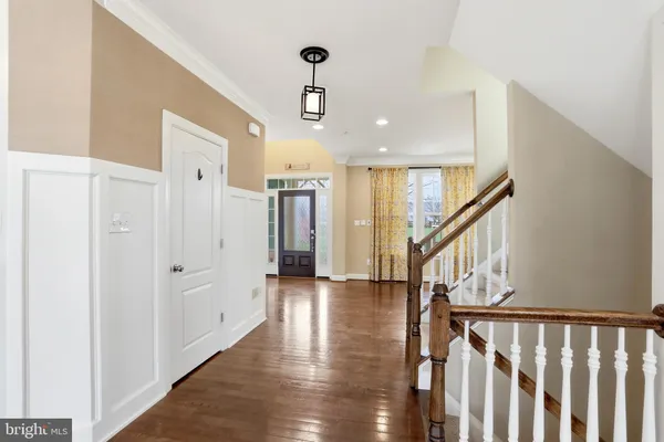 a view of an entryway with wooden floor and door