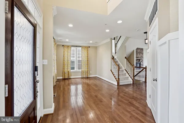 a view of entryway with wooden floor and stairs
