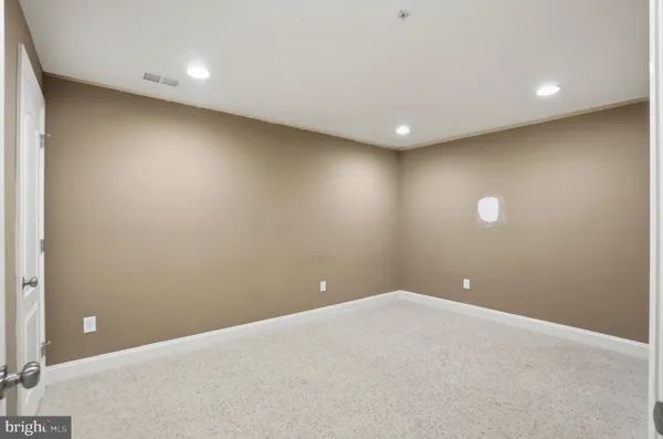 a view of a livingroom with a dishwasher and cabinets
