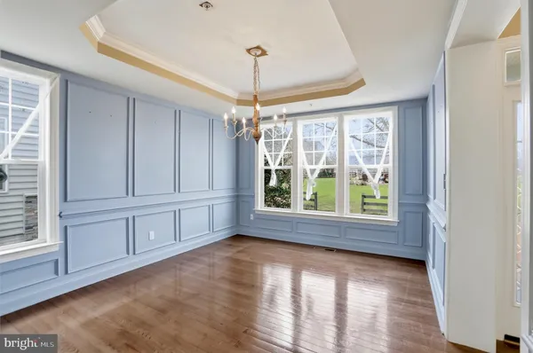 a view of a living room and kitchen with windows