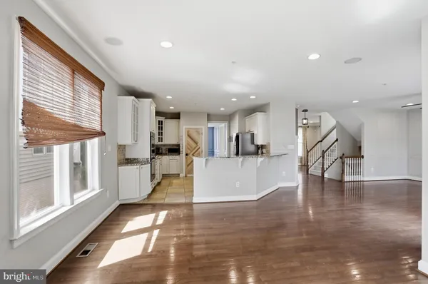 a view of kitchen with wooden floor and electronic appliances