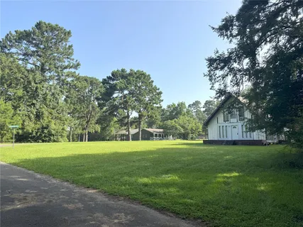 a view of grassy field with trees