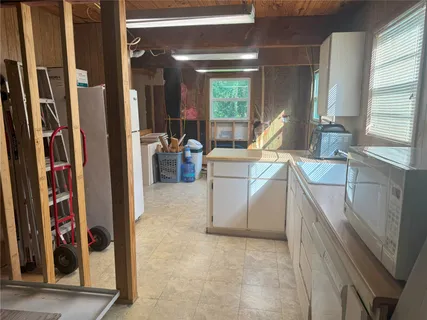a bathroom with a sink toilet and window