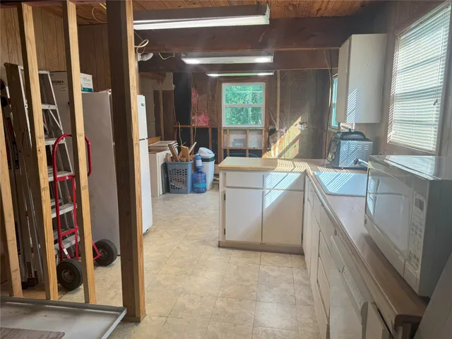 a bathroom with a sink toilet and window