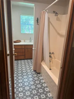 a view of a room with window and wooden floor