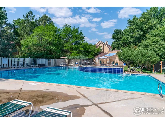 a view of backyard and wooden fence