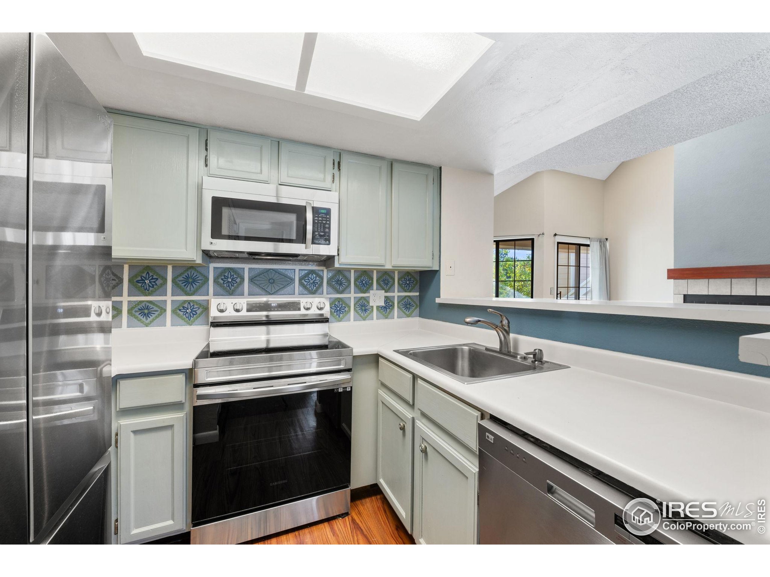5914 Gunbarrel Avenue, Unit F Boulder, CO 80301 - Photo 3 of 25 a kitchen with stainless steel appliances a stove sink and microwave
